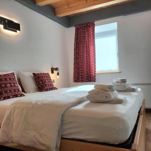 a bedroom with two beds and a window at Cà Soldati in Campi