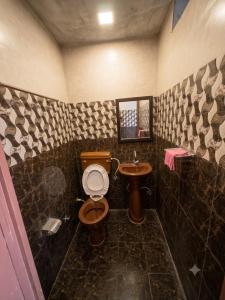 a bathroom with a toilet and a sink at crown house in Phagwāra +11 photos