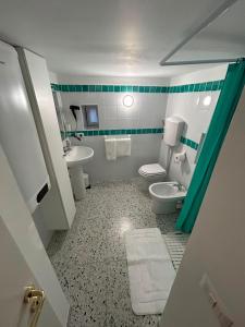 a bathroom with a white toilet and a sink at Casa Ninetta in Pimonte