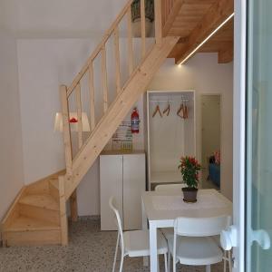 a kitchen and dining room with a table and a staircase at Casa Ninetta in Pimonte