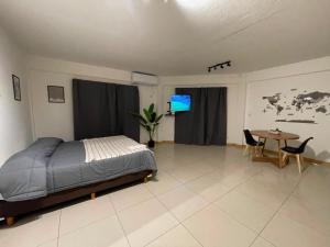 a bedroom with a bed and a table in it at Apart Escobar in Belén de Escobar