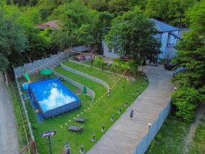 an image of a swimming pool in a park at Serenity Likani Villa Hotel in Borjomi