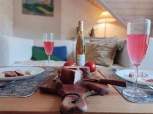 a wooden table with a bottle of wine and two glasses at Heritage House at Villa Sofia in Lahti