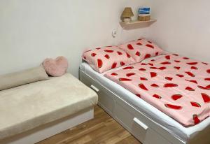 a bedroom with a bed with hearts on it at Vila Anička in Týnec nad Sázavou