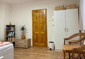 a room with a wooden door and a book shelf at Vila Anička in Týnec nad Sázavou