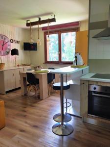 a kitchen with a table and chairs in a room at residence bungalow-Marmore in Folgarida +10 photos
