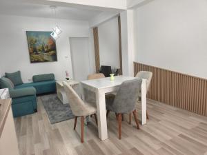a living room with a white table and chairs at N&L apartments in Strumica