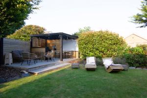 a backyard with a gazebo with a table and chairs at Coopers by the Coast in Selsey
