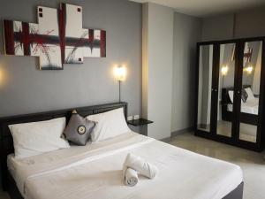 a bedroom with a bed with two slippers on it at Holiday Home Patong in Patong Beach