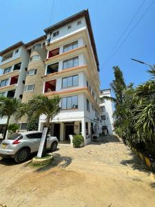 a building with a car parked in front of it at Silent breeze home in Mombasa