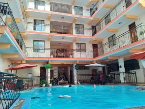 a swimming pool in the middle of a hotel at Silent breeze home in Mombasa