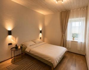 a bedroom with a bed and a window at Ulila guesthouse in Ulila