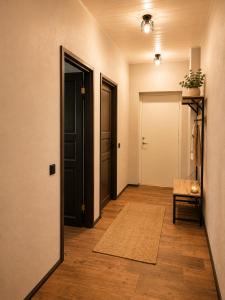 an empty hallway with a door and a rug at Ulila guesthouse in Ulila