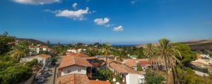 a town with palm trees and houses on a hill at Vel-Mer Lefke in Ayios Nikolaos