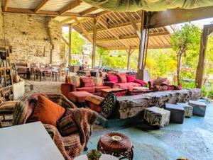 a large living room with couches and tables at Au Bonheur Nomade in Livry