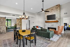 a living room with a couch and a table and a fireplace at Cambridge Cabin in Stanton