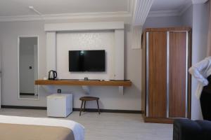 a hotel room with a tv on a wall at KILIÇ MOTEL in Istanbul