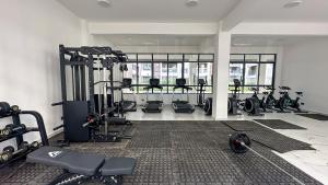 a gym with a bunch of treadmills and machines at Ultimate Safari Retreat,9min to Nairobi JKIA with Pool,Gym,WiFi and Binocular views in Nairobi