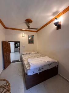 a bedroom with a bed and a ceiling fan at Moksha farms -3bhk private villa with pool and nature in Pālghar +26 photos