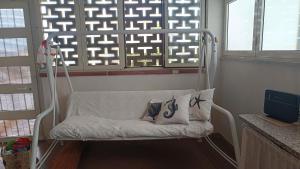 a white swing chair in a room with a window at Villa Aurora in Ispica