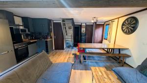 a living room with a couch and a table at La carrouere in Gujan-Mestras