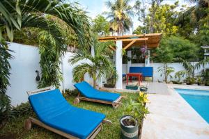a backyard with chairs and a swimming pool at Diani Luxe Villa in Galu
