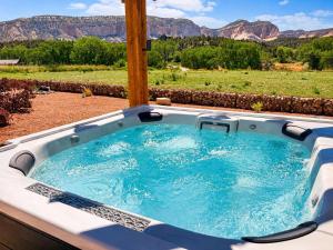 a jacuzzi tub with a view of the mountains at ABODE at East Zion in The Fields in Orderville