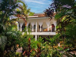 a white house with palm trees in front of it at The Verandas in Hinkong