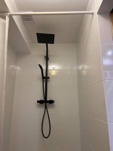 a shower with a shower head on a wall at Agroturystyka Evita in Jabłeczna +26 photos