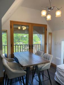 a dining room with a wooden table and chairs at Cabbagetown Inn in Toronto