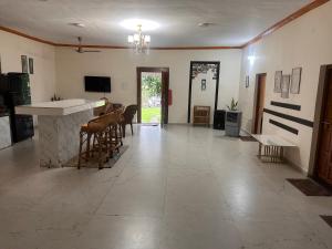 a lobby with chairs and a counter and a bar at Moksha farms -3bhk private villa with pool and nature in Pālghar