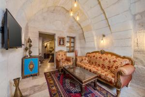 a living room with a couch and a table at Arcus Cappadocia in Göreme
