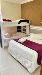 a bedroom with two bunk beds with towels on them at Villarejo Parque Hotel in Penha +118 photos