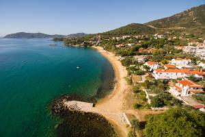an aerial view of a beach with houses and the ocean at Feel free in Paleo Tsifliki