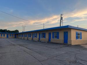 a row of buildings in a parking lot at Holiday Motel Tulsa OK in Tulsa