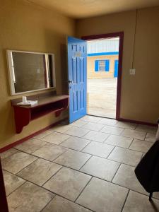 a room with a blue door and a tile floor at Holiday Motel Tulsa OK in Tulsa +15 photos