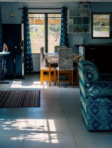 a living room with a table and a couch at Tovuka House Scuba too in Rakiraki