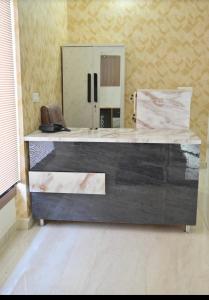 a room with a large desk with a mirror at Hotel shine plus in Kurukshetra
