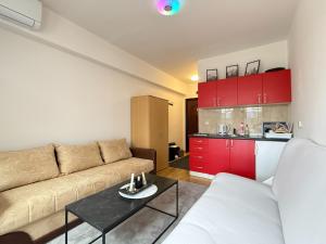 a living room with a couch and red cabinets at Apartman Natural Vlašić in Šišava