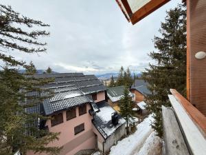 an apartment building with snow on the roof at Apartman Natural Vlašić in Šišava