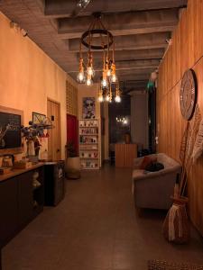 a living room with a couch and a clock on the wall at Treeloft Home in Girón