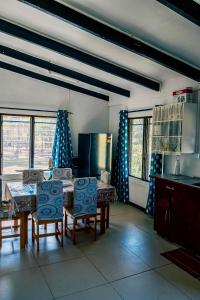 a kitchen with a table and chairs in a room at Tovuka House Scuba too in Rakiraki