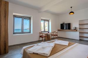 a bedroom with a bed and a table with chairs at Ondo Beach & Suites in Bodrum City