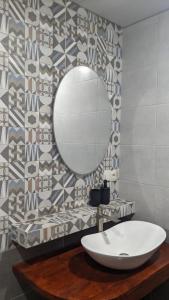 a bathroom with a white sink and a mirror at Villa Maiseli in Ambrolauri