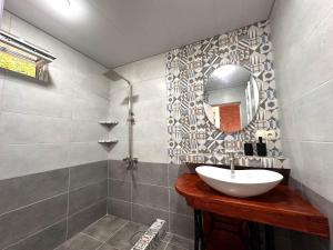 a bathroom with a sink and a mirror at Villa Maiseli in Ambrolauri +5 photos