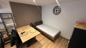 a small room with a table and a bed at Rondel in Žilina
