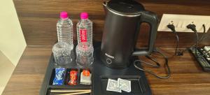 a black juicer with bottles of water on a table at Narayan Palace- Luxury Homestay in Varanasi
