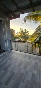 a balcony of a house with a view of the ocean at Haven Apartments- Nadi in Nadi