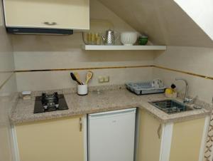 a small kitchen with a sink and a stove at BENYOUNECh in Belyounech  +5 photos