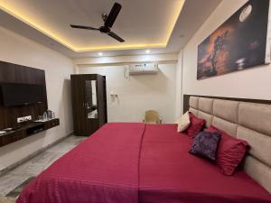 a bedroom with a large bed with a red blanket at Narayan Palace- Luxury Homestay in Varanasi
